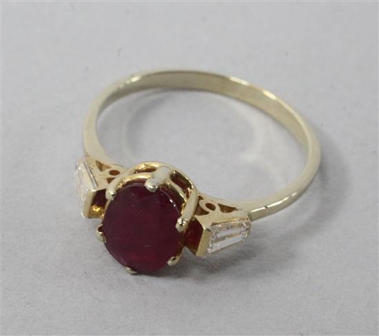 A 14ct and ruby ring with tapered cut diamond set shoulders, size L.